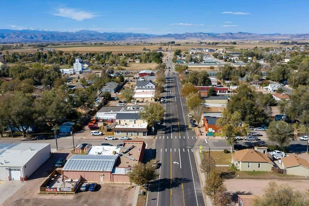 An aerial photograph of the picturesque downtown area and mountain view of Wellington, Colorado (CO)
